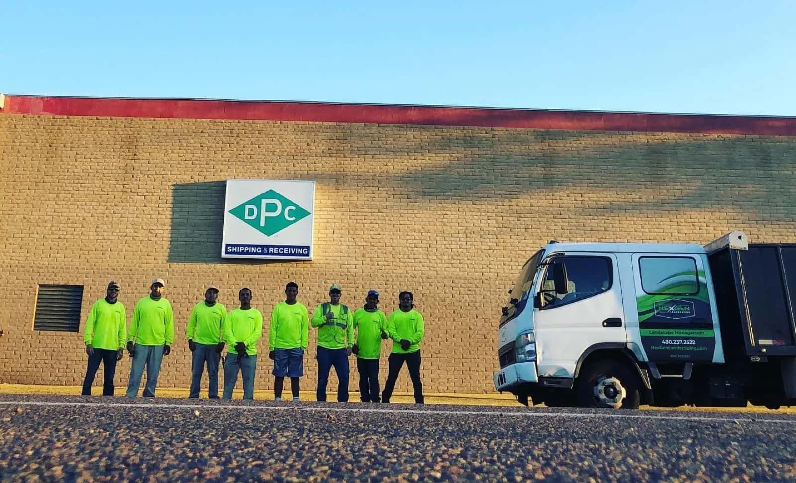 NexGen crew in hi-vis with the branded company truck on a commercial property in the Phoenix Metro